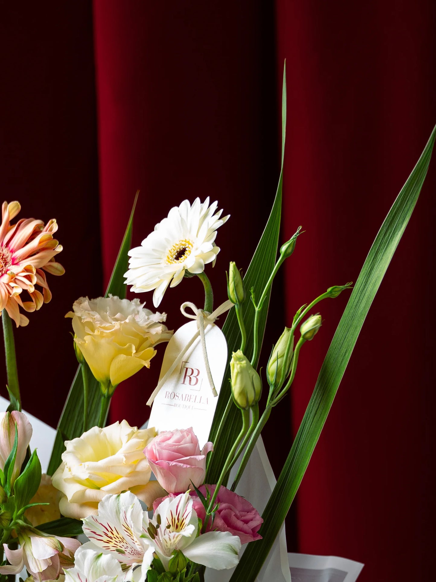 Milestone Blooms Handbag Arrangement with vibrant flowers in an elegant handbag, crafted as graduation flowers, available with delivery to Dubai, Sharjah, and Muwaileh.