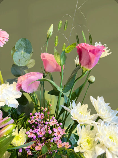 Cotton Candy Handbag Arrangement with pink, white, and green flowers, styled in a handbag with soft pink wrapping, available with flower delivery to Dubai and Sharjah.