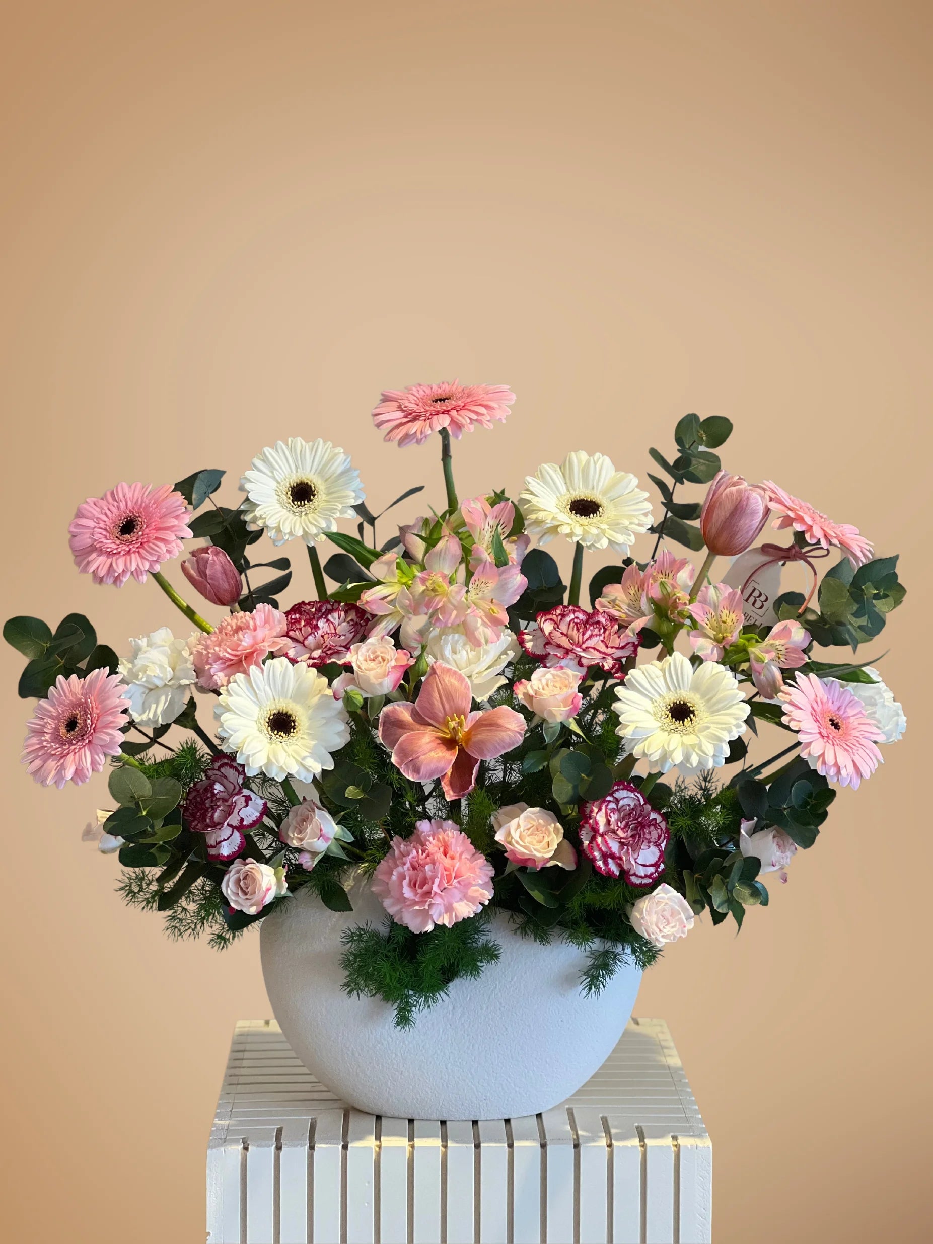 Divine Bloom Vase Arrangement with soft pink and white flowers, complemented by lush greenery, crafted by a flower shop in Muwaileh, offering flower delivery to Dubai.