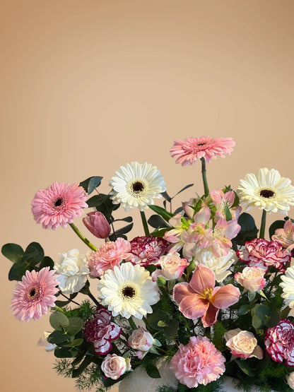 Divine Bloom Vase Arrangement with soft pink and white flowers, complemented by lush greenery, crafted by a flower shop in Muwaileh, offering flower delivery to Dubai.