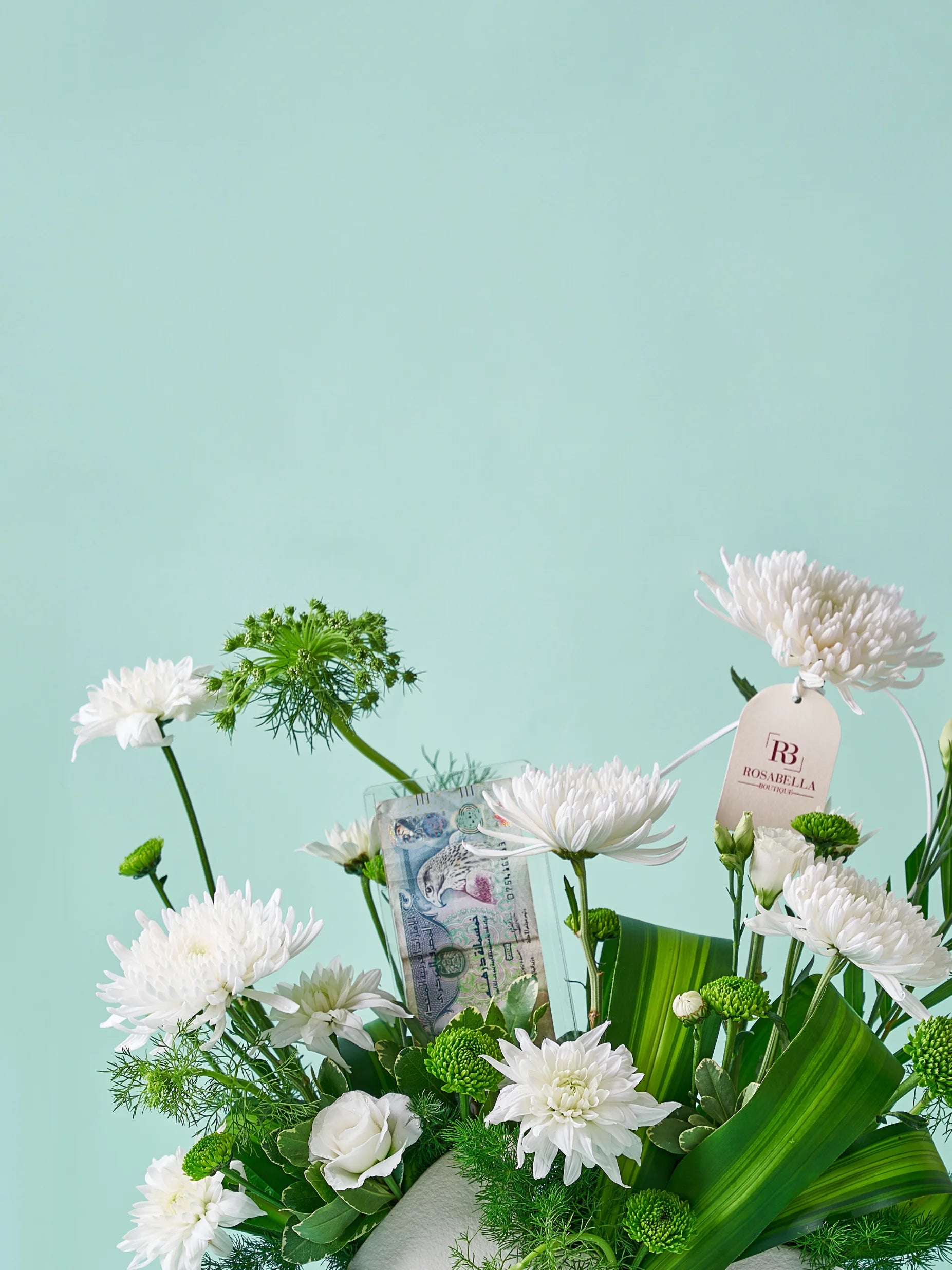 Ethereal Greens Vase Arrangement with white flowers and lush greenery in a ceramic vase, available at a flower boutique with delivery to Dubai, Sharjah, and Muwaileh.