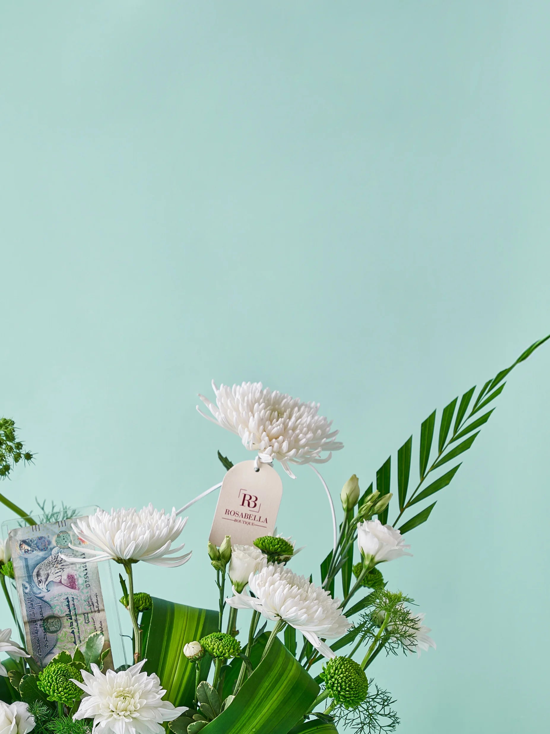 Ethereal Greens Vase Arrangement with white flowers and lush greenery in a ceramic vase, available at a flower boutique with delivery to Dubai, Sharjah, and Muwaileh.