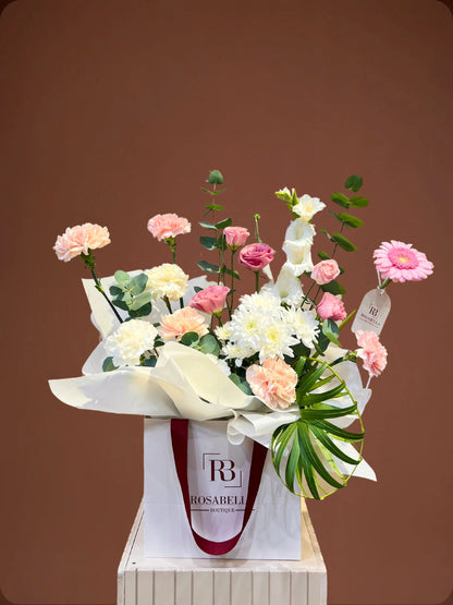 Grace Handbag Arrangement with pink and white flowers in a stylish handbag, available at a flower shop in Muwaileh with delivery to Dubai and Sharjah.