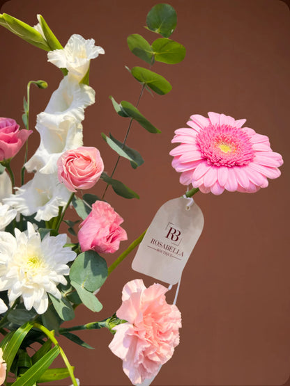 Grace Handbag Arrangement with pink and white flowers in a stylish handbag, available at a flower shop in Muwaileh with delivery to Dubai and Sharjah.