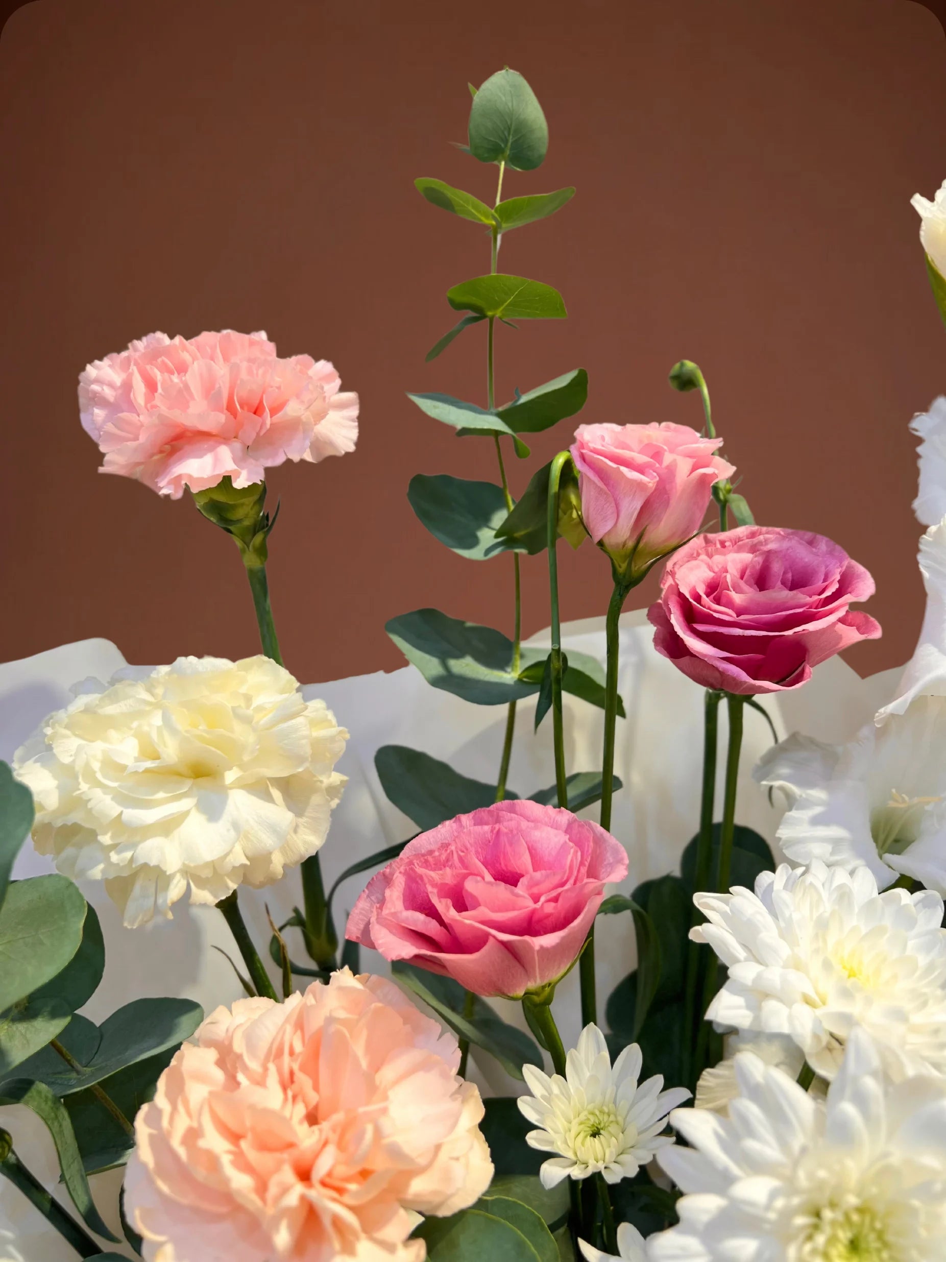 Grace Handbag Arrangement with pink and white flowers in a stylish handbag, available at a flower shop in Muwaileh with delivery to Dubai and Sharjah.