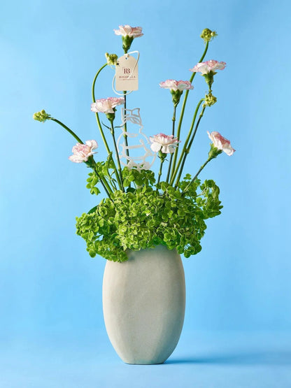 Little Wonder Vase Arrangement with delicate pink blooms and lush greens in a tall vase, crafted by Rosabella Boutique with flower delivery available to Dubai and Sharjah.