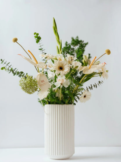 Lush Oasis Vase Arrangement with soft white flowers and vibrant greenery in a modern vase, available at a flower shop near me with delivery to Dubai and Sharjah.