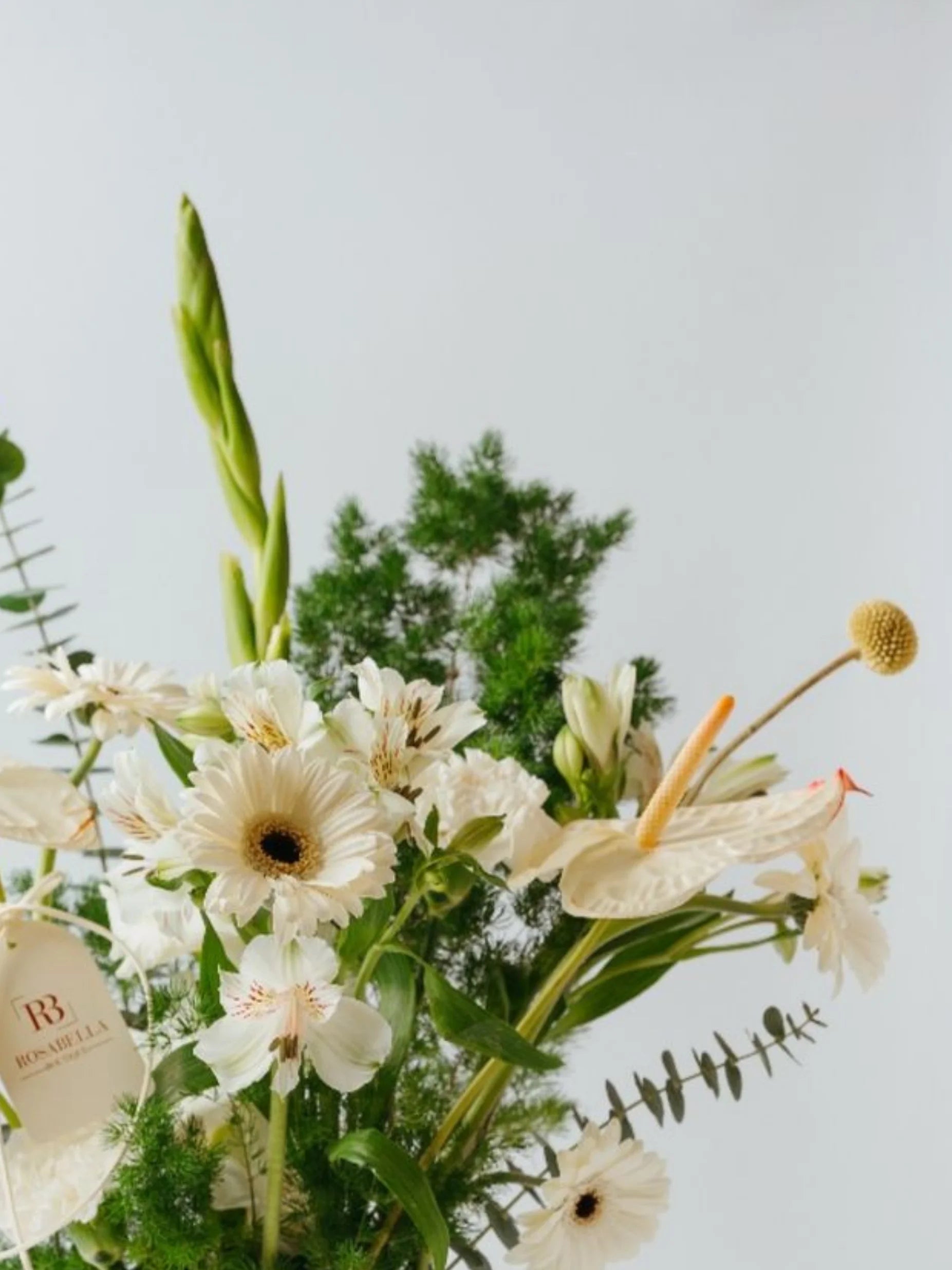 Lush Oasis Vase Arrangement with soft white flowers and vibrant greenery in a modern vase, available at a flower shop near me with delivery to Dubai and Sharjah.