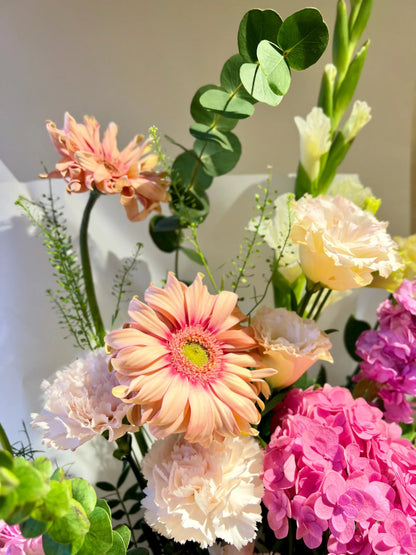 Orchid Splendor Handbag Arrangement with vibrant Gerberas and exquisite orchids in a stylish handbag, available as special flowers with delivery to Dubai, Sharjah, and Muwaileh.