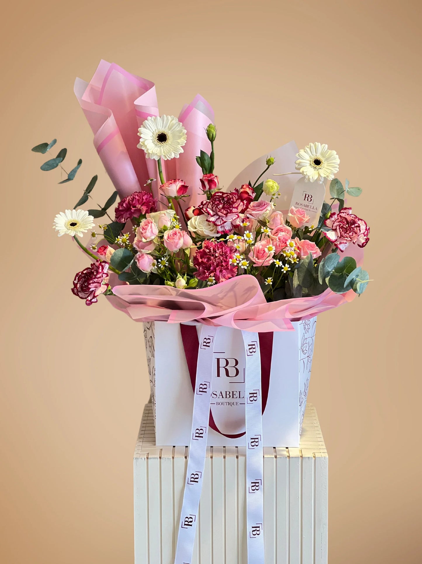 Pink Opulence Handbag Arrangement with vibrant pink and soft white blooms in a chic handbag, available with flower delivery to Dubai, Sharjah, and Muwaileh.