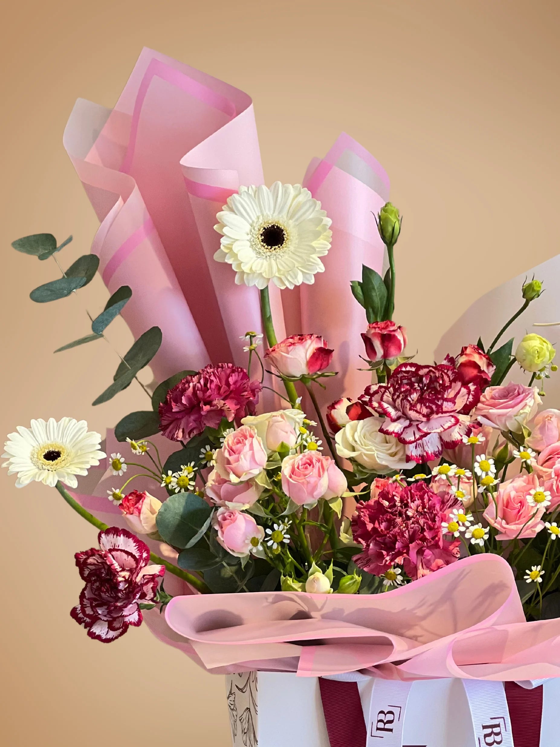 Pink Opulence Handbag Arrangement with vibrant pink and soft white blooms in a chic handbag, available with flower delivery to Dubai, Sharjah, and Muwaileh.