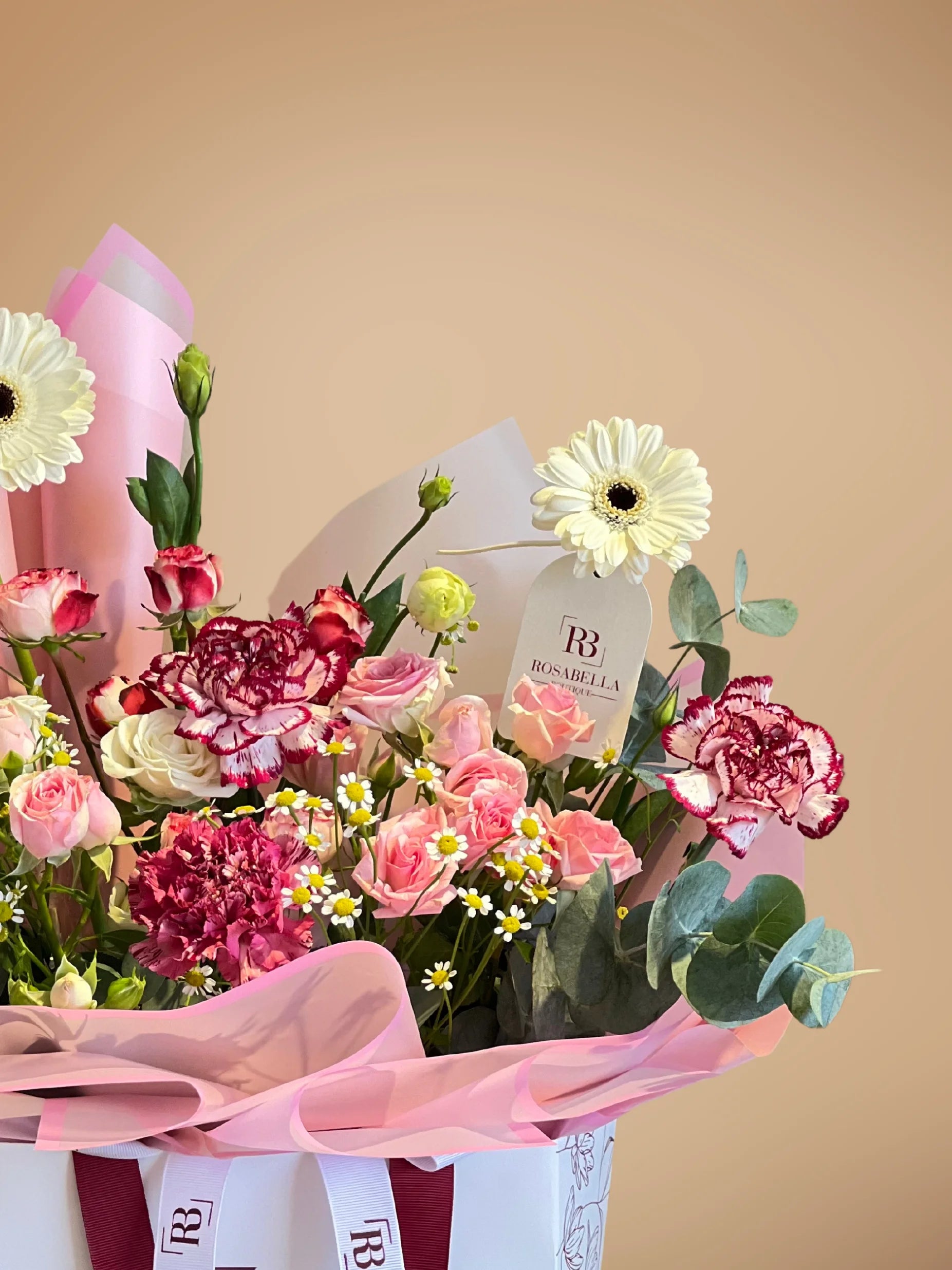 Pink Opulence Handbag Arrangement with vibrant pink and soft white blooms in a chic handbag, available with flower delivery to Dubai, Sharjah, and Muwaileh.