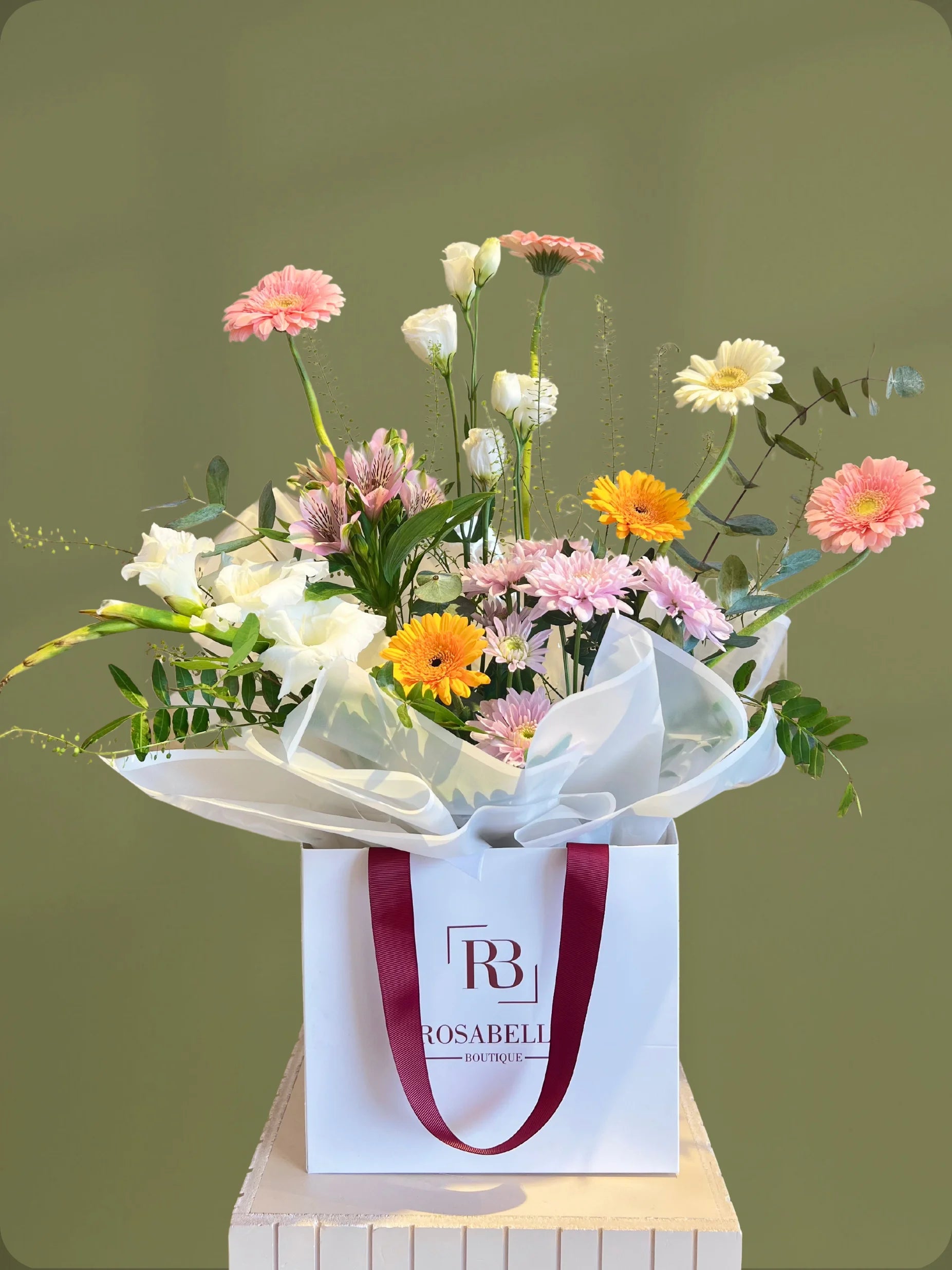 Verdant Handbag Arrangement with green, white, yellow, and pink flowers in a chic handbag, available as special flowers with delivery to Dubai, Sharjah, and Muwaileh.