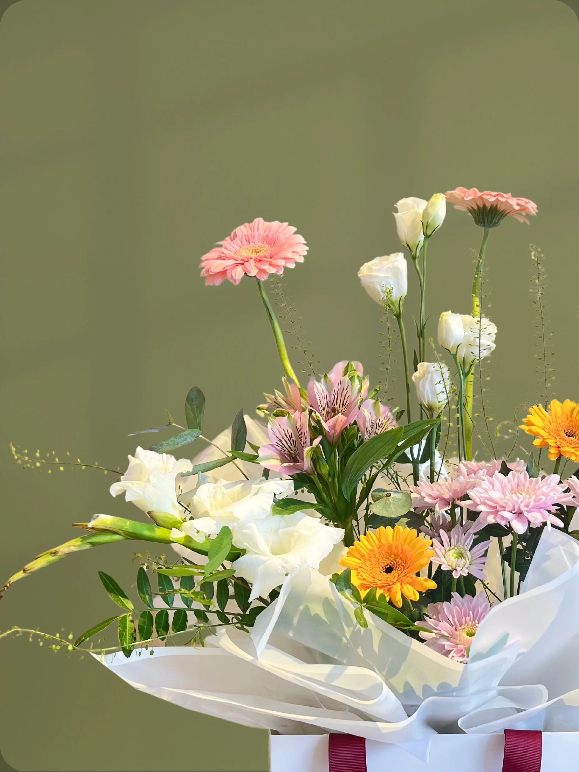 Verdant Handbag Arrangement with green, white, yellow, and pink flowers in a chic handbag, available as special flowers with delivery to Dubai, Sharjah, and Muwaileh.