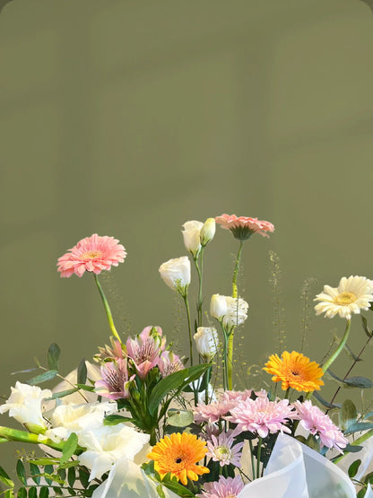 Verdant Handbag Arrangement with green, white, yellow, and pink flowers in a chic handbag, available as special flowers with delivery to Dubai, Sharjah, and Muwaileh.